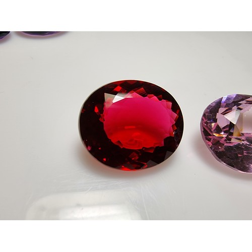 405 - A selection of 6 faceted gemstones to include 2 genuine tested as amethyst faceted gemstones and 4 o... 