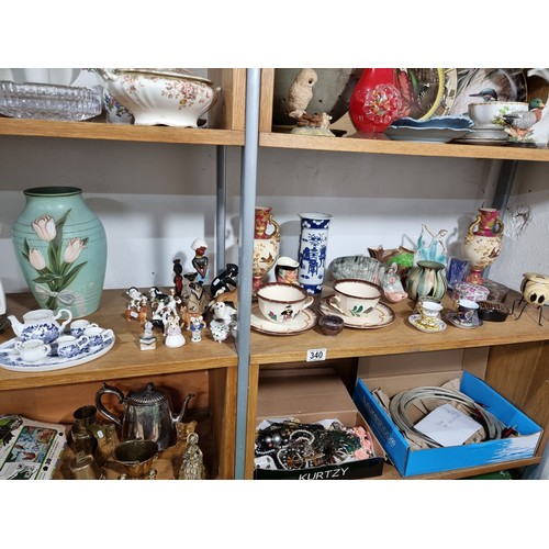 340 - A shelf full of good quality collectables including an interesting antique blue and white Chinese va... 