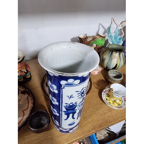 340 - A shelf full of good quality collectables including an interesting antique blue and white Chinese va... 
