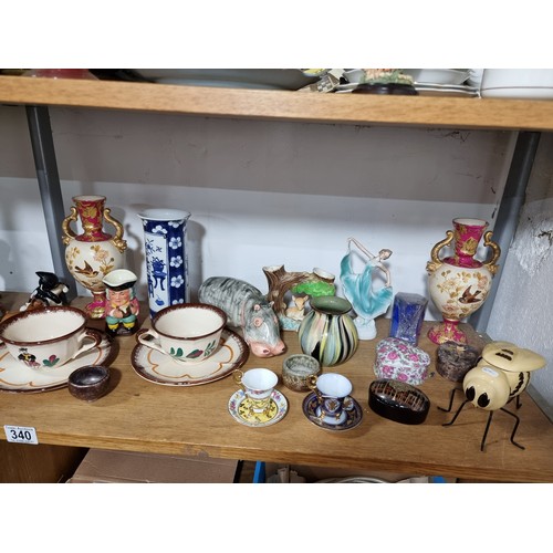 340 - A shelf full of good quality collectables including an interesting antique blue and white Chinese va... 