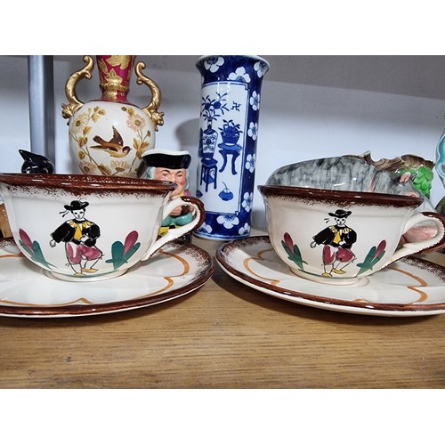 340 - A shelf full of good quality collectables including an interesting antique blue and white Chinese va... 