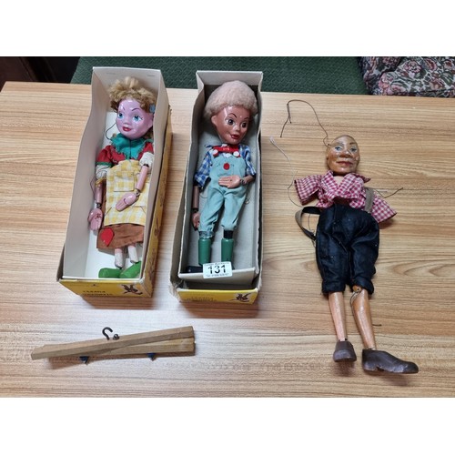 131 - 2x vintage boxed Pelham puppets along with one other vintage wooden puppet (missing arms).