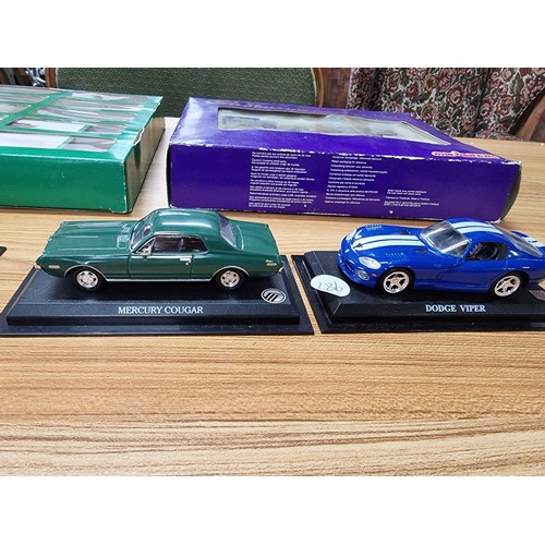 132 - A quantity of collectable die cast cars to include a Christmas collection 10 car boxed set by Cameo ... 