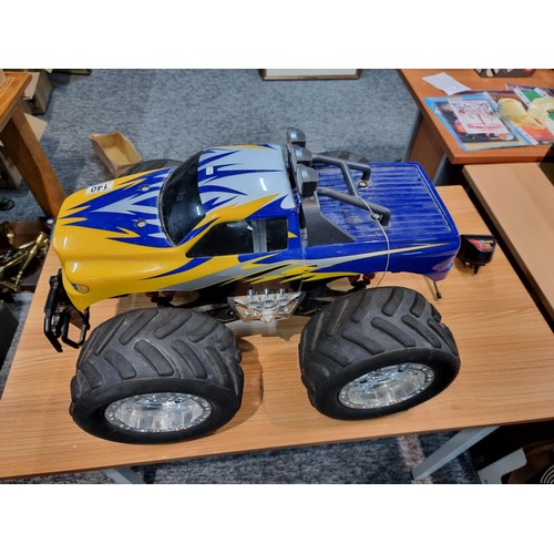 140 - A very large RC 4x4 monster truck complete with controller and charger featuring giant wheels. Heigh... 