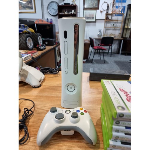 144 - An Xbox 360 gaming console complete with 20 good games, steering wheel and pedals, controller and po... 