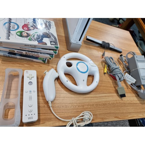 145 - A Nintendo Wii games console complete with 10 games inc Mario Kart controllers, the Mario Kart wheel... 