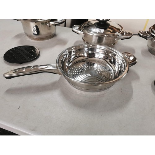 35 - Quantity of good quality unused pan set to include 2 pots, a steamer and a frying pan, 2 lids with t... 