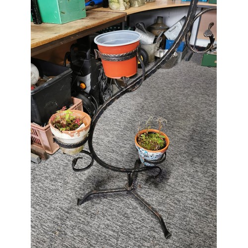 59 - 5 tier wrought iron plant stand containing 3x terracotta plant pots and one other stands 132cm high