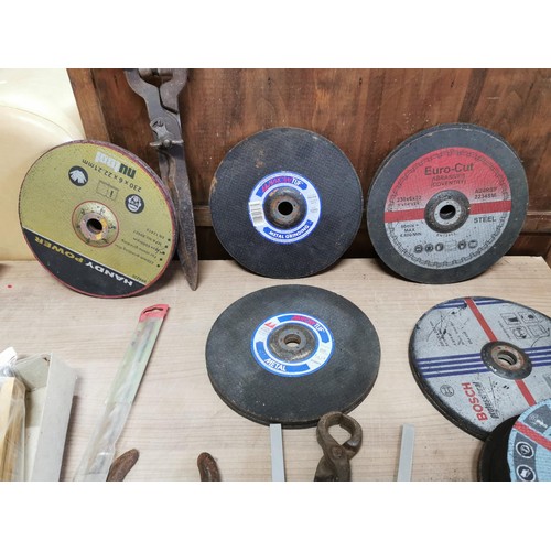 73 - Box containing a large quantity of grinding disks along with pick axe head, shears, staplers tape me... 