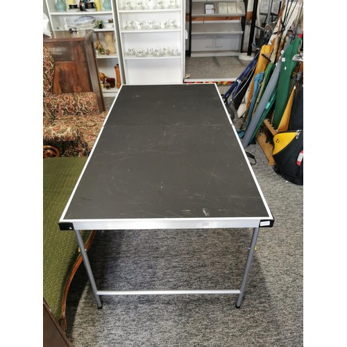 101 - A large folding aluminium table with black surface in overall good condition a few minor scratches t... 