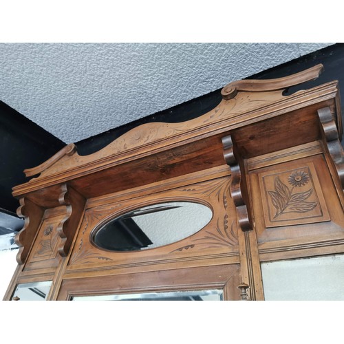 107 - Good quality oak well detailed mirrored over mantel with floral carving decoration and 4x shelves he... 