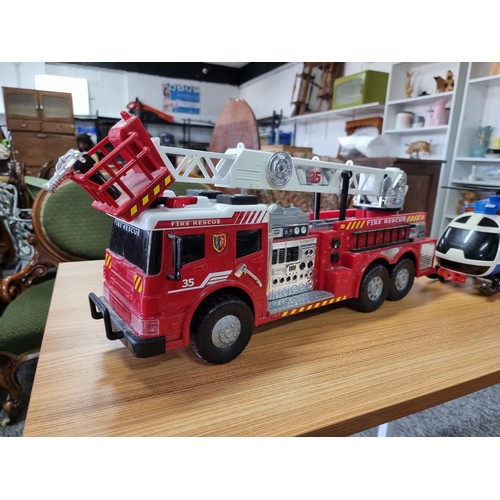 166 - A large battery powered children's fire engine toy along with a battery powered helicopter toy, both... 