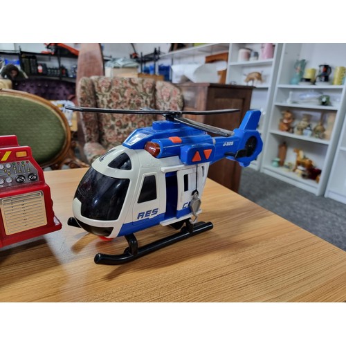 166 - A large battery powered children's fire engine toy along with a battery powered helicopter toy, both... 