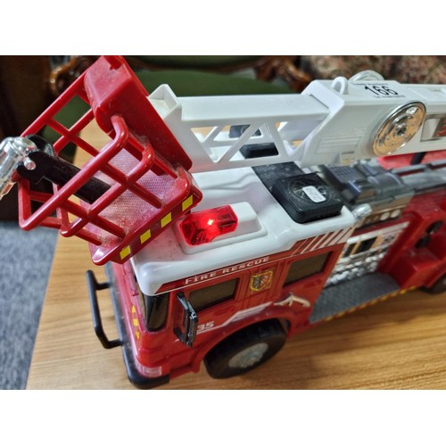 166 - A large battery powered children's fire engine toy along with a battery powered helicopter toy, both... 