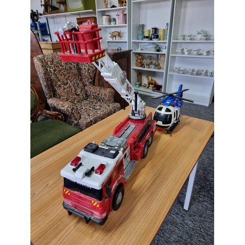 166 - A large battery powered children's fire engine toy along with a battery powered helicopter toy, both... 