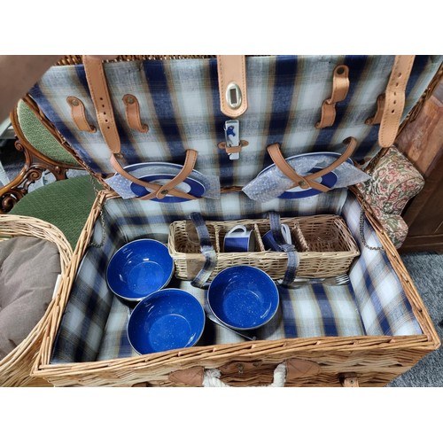 187 - 2 wicker picnic baskets with contents along with a wicker dog bed and 2 large solid wood carved ethn... 