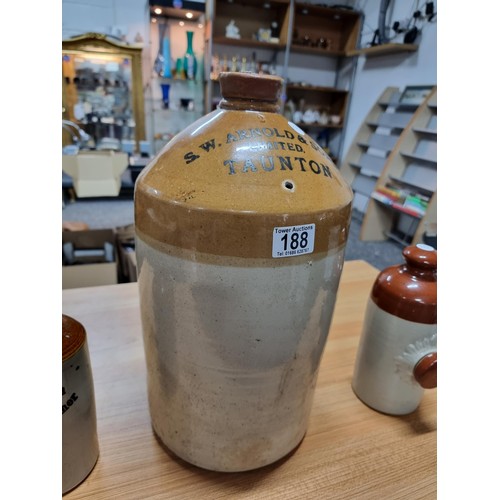 188 - A large vintage stoneware flagon along with 2 vintage stoneware foot warmers. The flagon is marked f... 