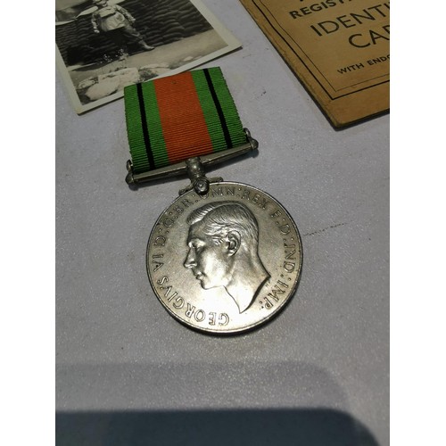 242 - Vintage Id card and defence medal for WWII for Fred Sutton along with a battle of Britain booklet au... 