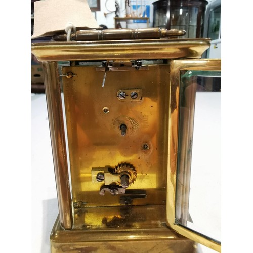 243 - Good quality early vintage brass carriage clock with a visible escapement to the top bevel edge glas... 