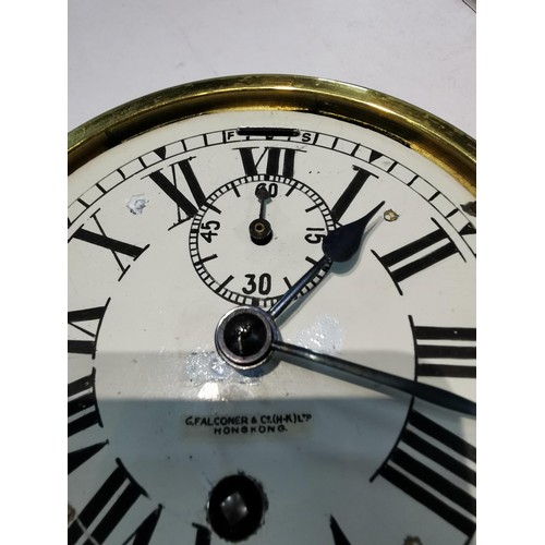 244 - Vintage brass ships clock G.Falconer (H-K) ltd Hong Kong. with bevelled edged glass and enamel dial