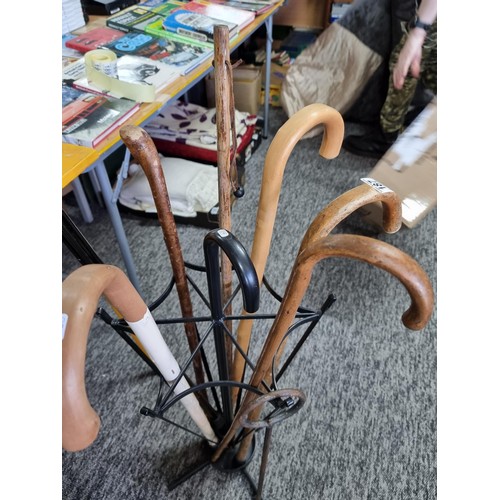 205 - Metal umbrella formed walking stick / umbrella stand containing 8x various walking sticks. All in go... 