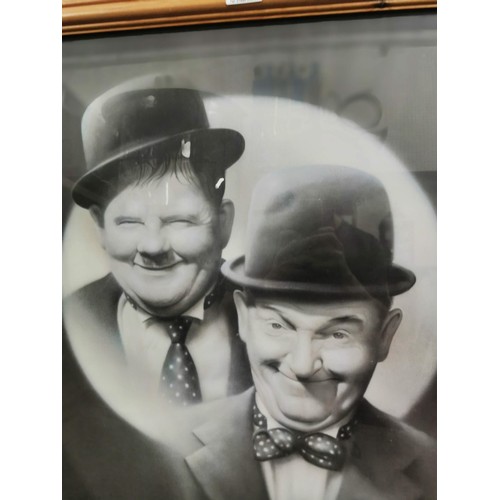 206 - Framed and glazed print Laurel and Hardy signed S. Coffield height 77cm by 58cm