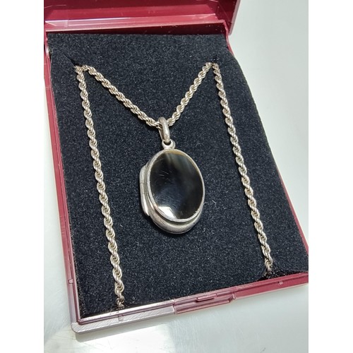 257 - A 925 silver locket pendant inset with a black nephrite stone and set on a good thick 18