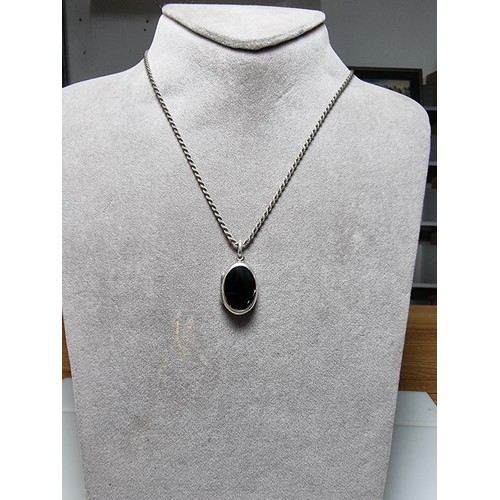 257 - A 925 silver locket pendant inset with a black nephrite stone and set on a good thick 18