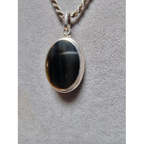 257 - A 925 silver locket pendant inset with a black nephrite stone and set on a good thick 18