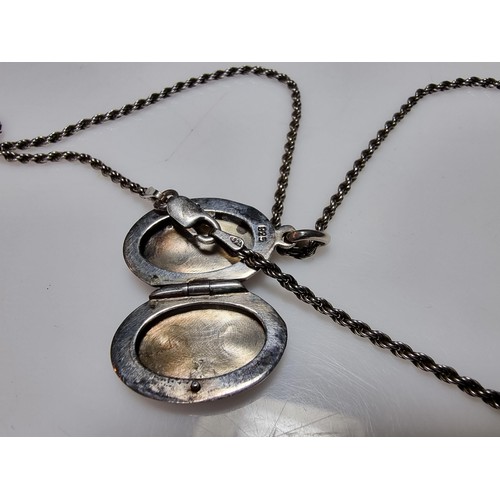 257 - A 925 silver locket pendant inset with a black nephrite stone and set on a good thick 18