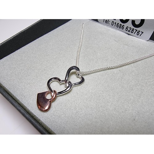 263 - An unused 925 silver 3 heart pendant on an 18