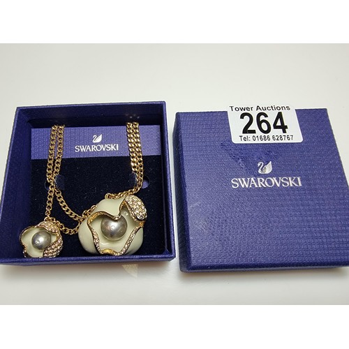 264 - A genuine Swarovski unusual enamelled flower pendant and charm on a double gold tone neck chain, pen... 