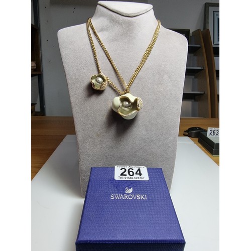 264 - A genuine Swarovski unusual enamelled flower pendant and charm on a double gold tone neck chain, pen... 