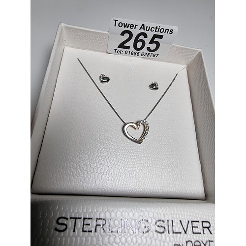 265 - An unused sterling silver heart pendant chain and matching earrings by next.