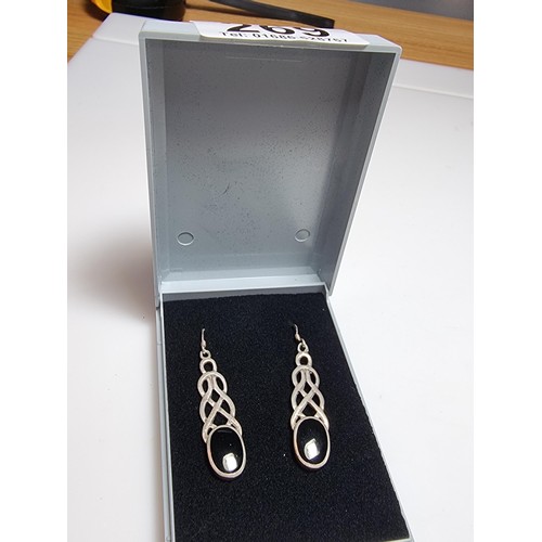 269 - A pair of pretty long drop 925 silver earrings inset with black onyx stones with a Celtic design. Le... 