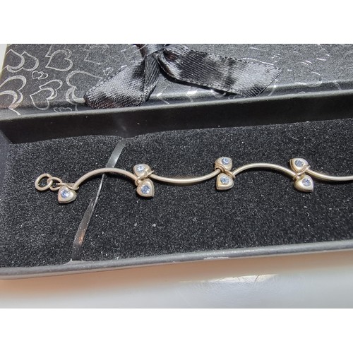 271 - A 925 silver vine formed bracelet inset with blue stones in good condition missing one stone, boxed.... 