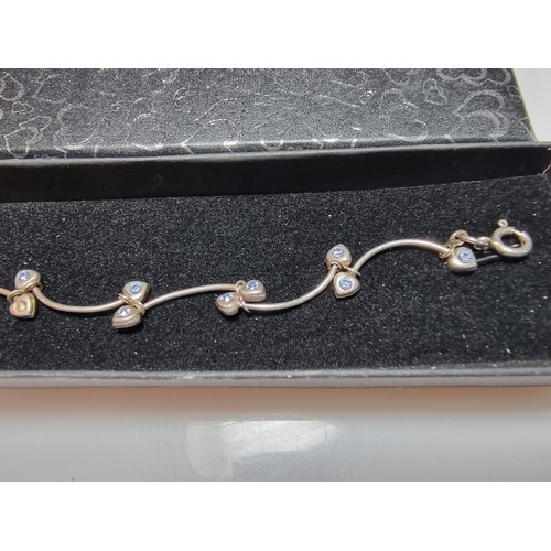 271 - A 925 silver vine formed bracelet inset with blue stones in good condition missing one stone, boxed.... 