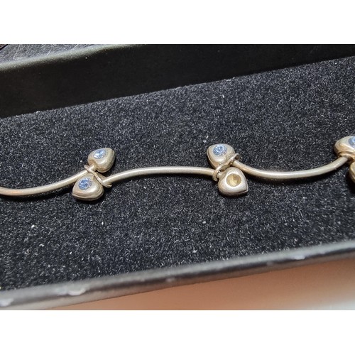 271 - A 925 silver vine formed bracelet inset with blue stones in good condition missing one stone, boxed.... 