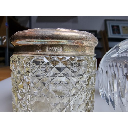 300 - A crystal glass pot with a hallmarked silver top along with a crystal glass scent bottle with a ster... 