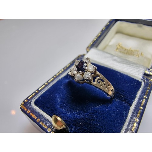 284 - A pretty gold on 925 silver flower ring inset with a blue sapphire stone a clear CZ stones, in clean... 