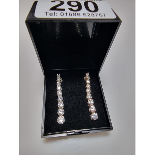 290 - A pair of impressive as new 925 silver drop stud earrings inset with graduated crystal CZ stones whi... 