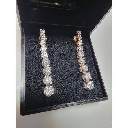 290 - A pair of impressive as new 925 silver drop stud earrings inset with graduated crystal CZ stones whi... 