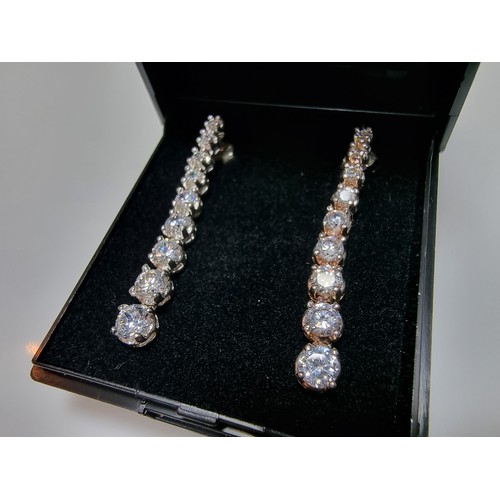 290 - A pair of impressive as new 925 silver drop stud earrings inset with graduated crystal CZ stones whi... 