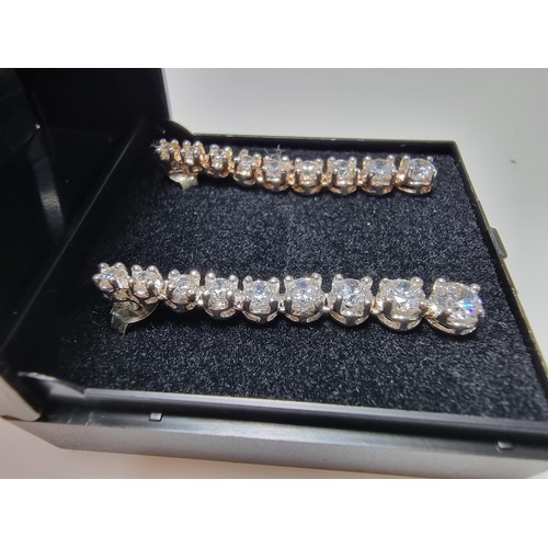 290 - A pair of impressive as new 925 silver drop stud earrings inset with graduated crystal CZ stones whi... 