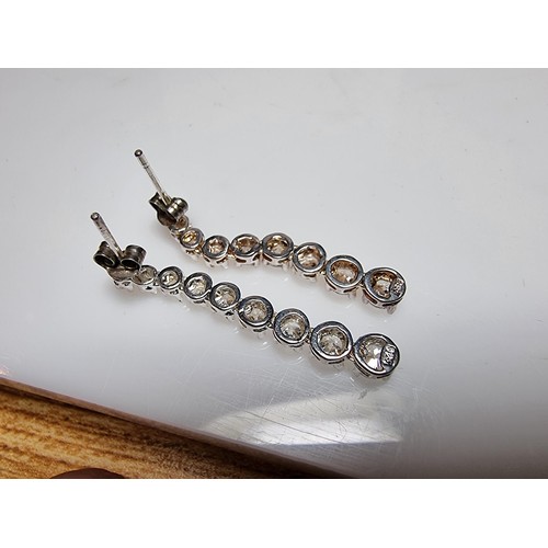 290 - A pair of impressive as new 925 silver drop stud earrings inset with graduated crystal CZ stones whi... 