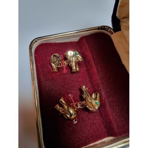 298 - A pair of unused vintage 18k gold plated elephant formed cufflinks with green gemstone eyes, never h... 