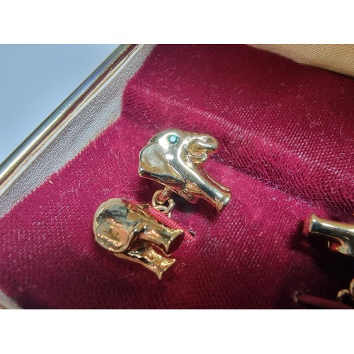 298 - A pair of unused vintage 18k gold plated elephant formed cufflinks with green gemstone eyes, never h... 