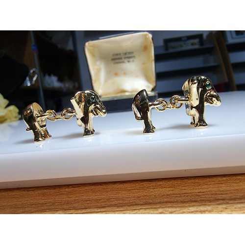 298 - A pair of unused vintage 18k gold plated elephant formed cufflinks with green gemstone eyes, never h... 