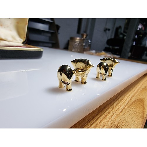 298 - A pair of unused vintage 18k gold plated elephant formed cufflinks with green gemstone eyes, never h... 