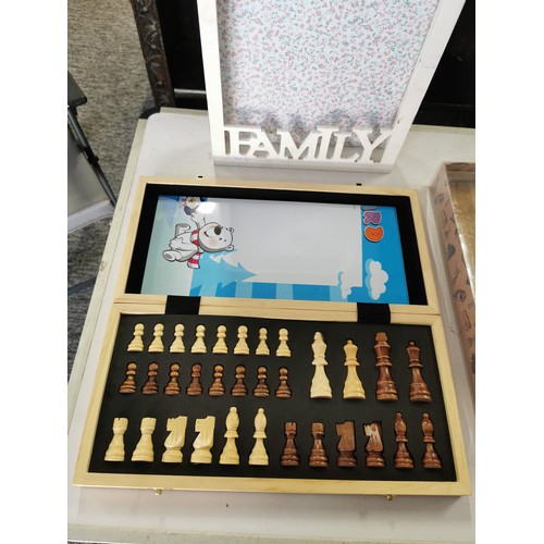 17 - A wooden chess board, a wooden key rack, and a boxed cheese plate with dishes.